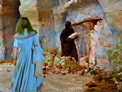 The bear is knocking out a cave in the rock face